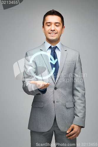 Image of happy businessman in suit showing circle arrow