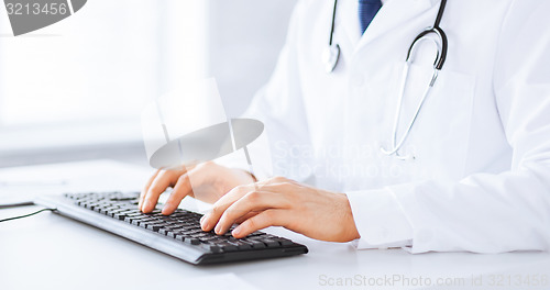 Image of male doctor typing  on the keyboard