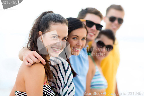 Image of group of happy friends on beach