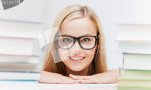 Image of student with stack of books