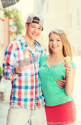Image of smiling couple with ice-cream in city