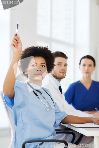 Image of group of happy doctors on conference at hospital