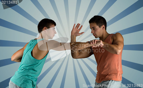 Image of young men fighting hand-to-hand