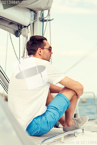 Image of man sitting on yacht deck
