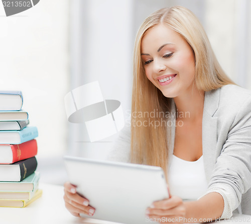 Image of student with books and tablet pc