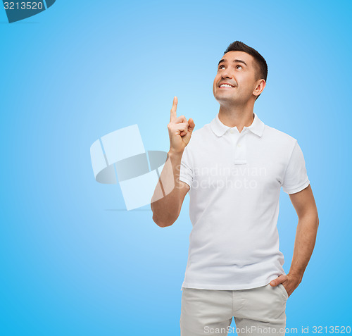 Image of smiling man pointing finger up