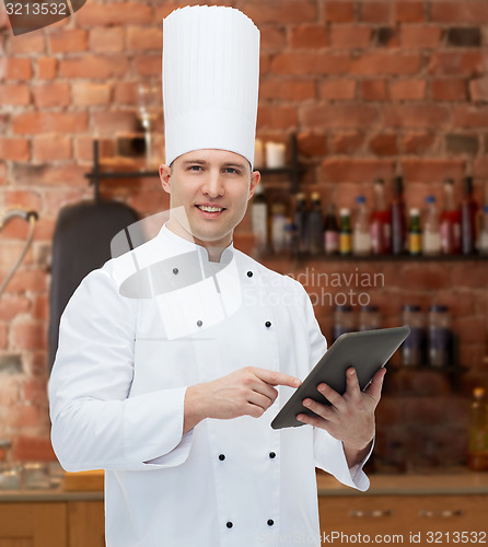 Image of happy male chef cook holding tablet pc