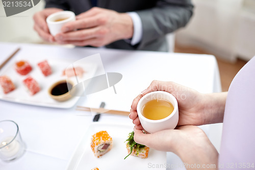 Image of close up of couple drinking tea at restaurant