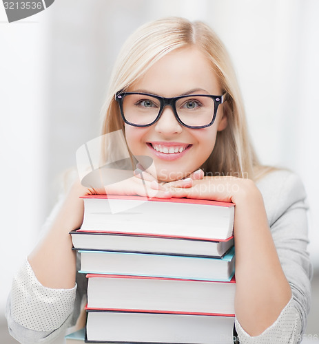 Image of student with stack of books