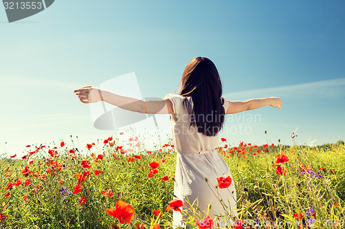 Image of young woman on poppy field