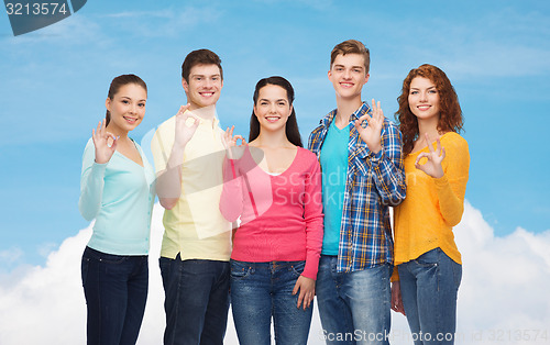 Image of group of smiling teenagers showing ok sign