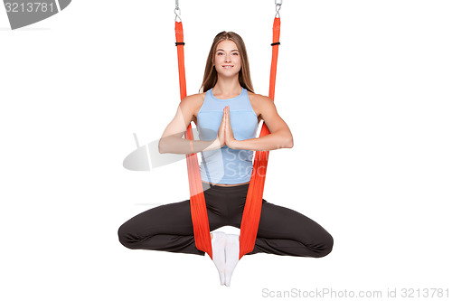 Image of Young woman doing anti-gravity aerial yoga