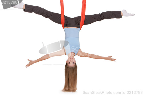 Image of Young woman making antigravity yoga exercises in stretching twine