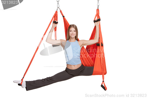 Image of Young woman making antigravity yoga exercises in stretching twine