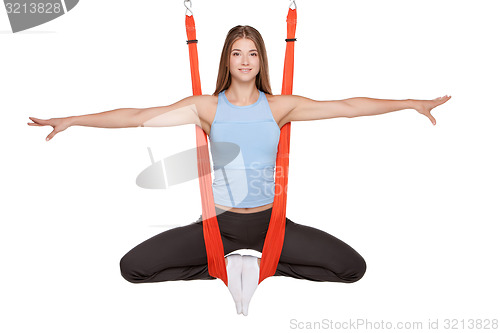 Image of Young woman doing anti-gravity aerial yoga