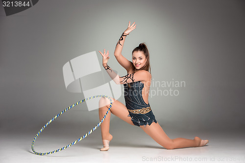 Image of teenager doing gymnastics exercises with colorful hoop