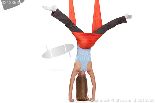 Image of Young woman making antigravity yoga exercises in stretching twine