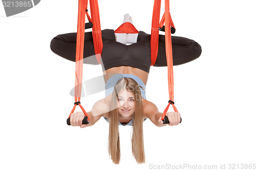 Image of Young woman making antigravity yoga exercises in stretching twine