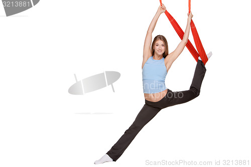 Image of Young woman making antigravity yoga exercises in stretching twine