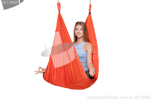 Image of Young woman doing anti-gravity aerial yoga