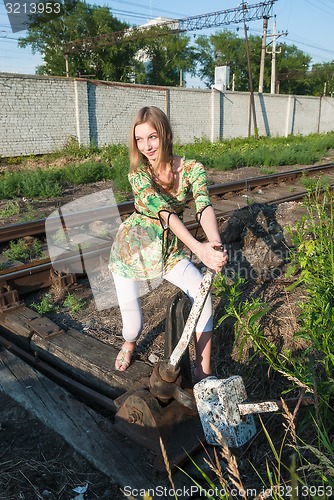 Image of Pretty girl throws railway switch