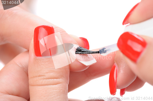 Image of manicure, applying clear enamel