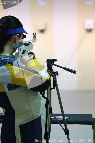 Image of woman aiming a pneumatic air rifle