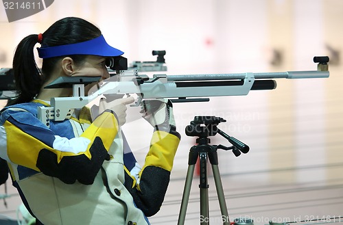 Image of woman aiming a pneumatic air rifle