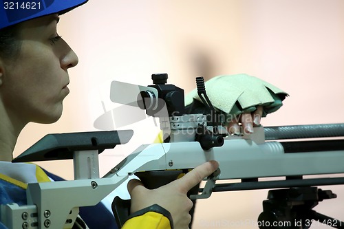 Image of woman aiming a pneumatic air rifle