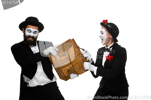 Image of Business man and woman fighting over briefcase