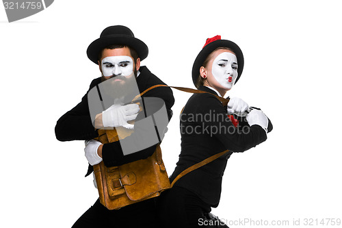 Image of Business man and woman fighting over briefcase