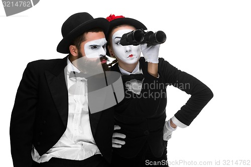 Image of Two memes as business people looking through binoculars 