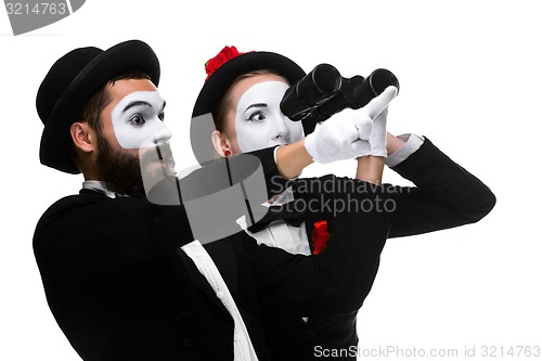 Image of Two memes as business people looking through binoculars 