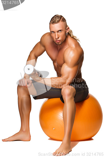 Image of Shaped and healthy body man sitting on fitness ball 