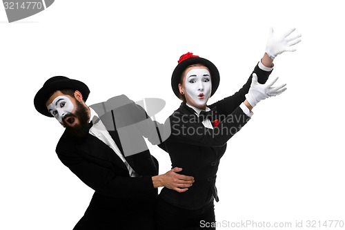 Image of mime holding another one up and running