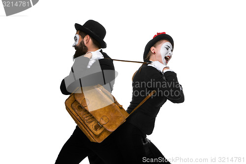 Image of Business man and woman fighting over briefcase