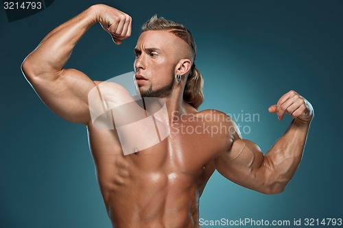 Image of Attractive male body builder on blue background