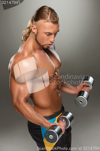 Image of Attractive male body builder on gray background