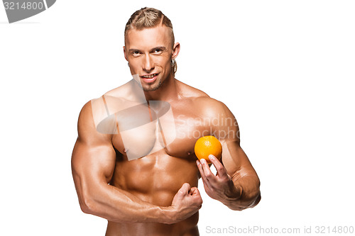 Image of Shaped and healthy body man holding a fresh orange fruit,  isolated on white background