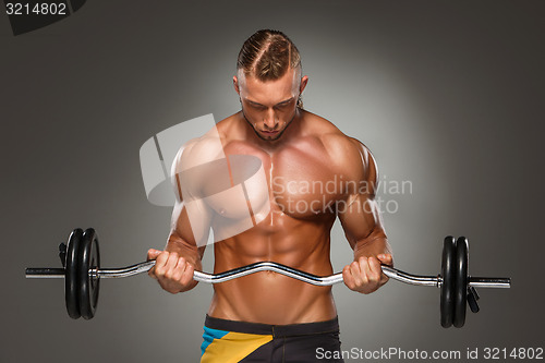 Image of Portrait of super fit muscular young man working out in gym.