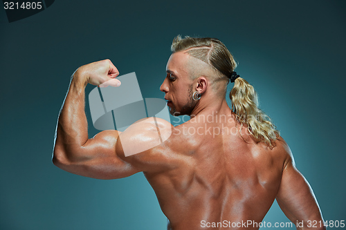 Image of Attractive male body builder on blue background