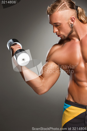 Image of Attractive male body builder on gray background