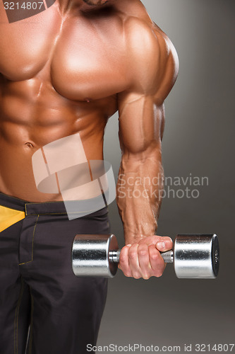 Image of Attractive male body builder on gray background