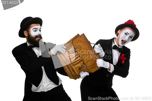 Image of Business man and woman fighting over briefcase