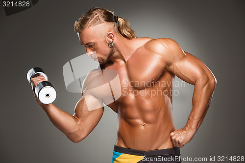 Image of Attractive male body builder on gray background