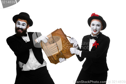 Image of Business man and woman fighting over briefcase