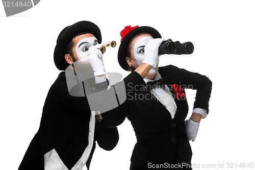 Image of Two memes as business people looking through binoculars 