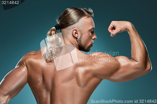 Image of Attractive male body builder on blue background