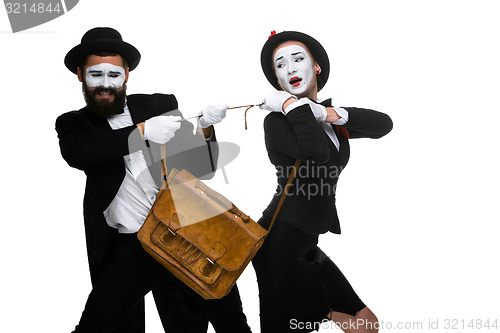 Image of Business man and woman fighting over briefcase