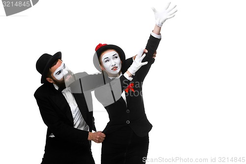 Image of mime holding another one up and running